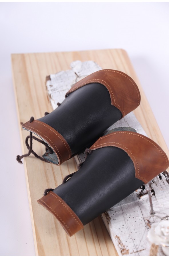 Medieval brown and black leather bracers with rivets